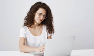 A woman at a laptop measuring legal SEO results.